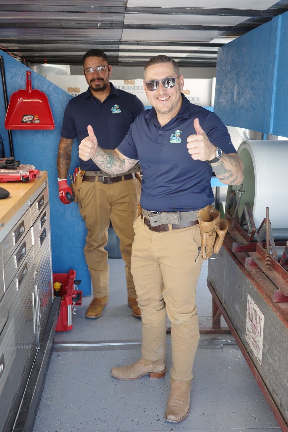 Technicians in the Gutter Duck seamless gutter fabrication trailer