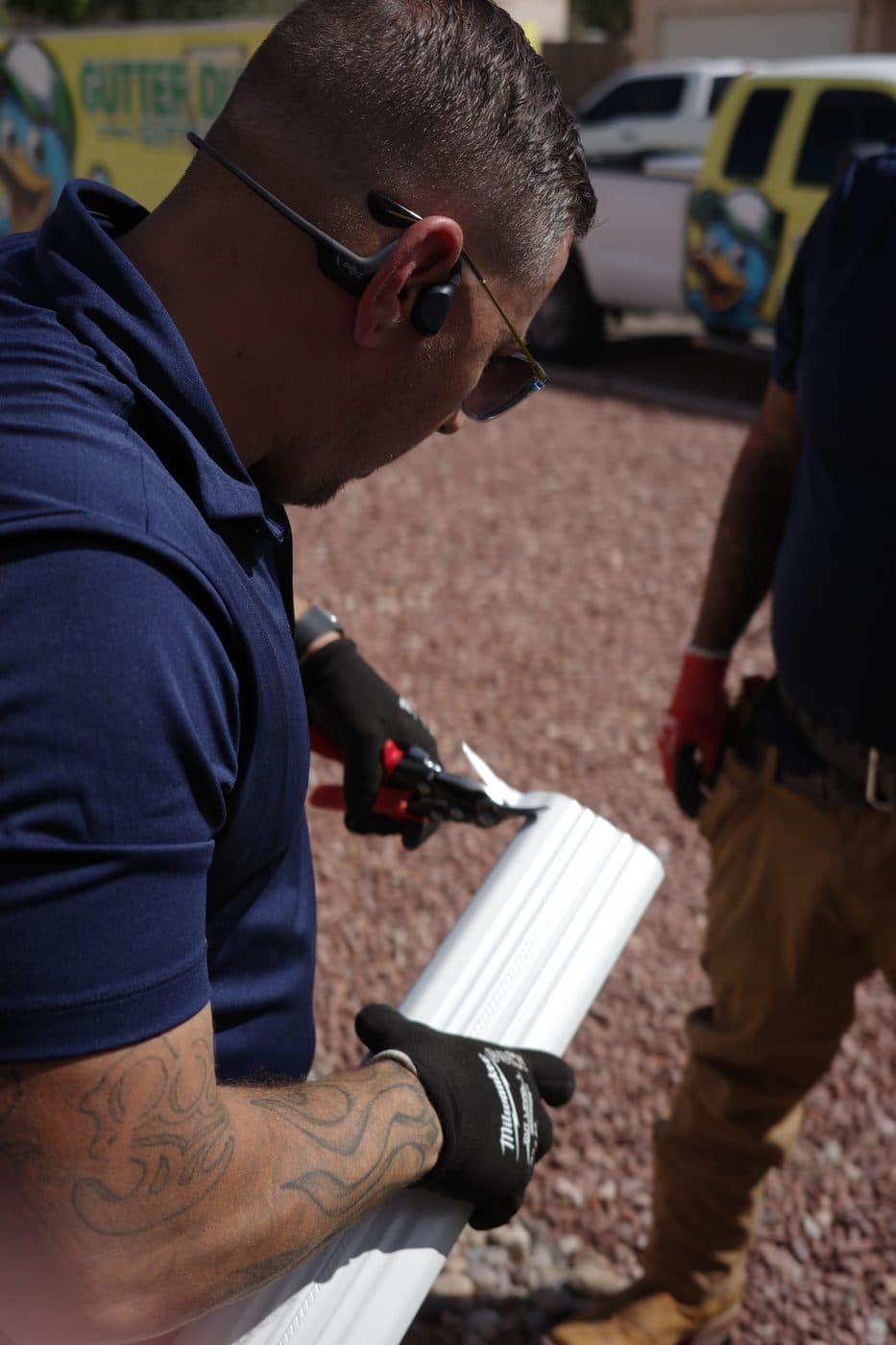 Technician applying sealant to a new seamless gutter section