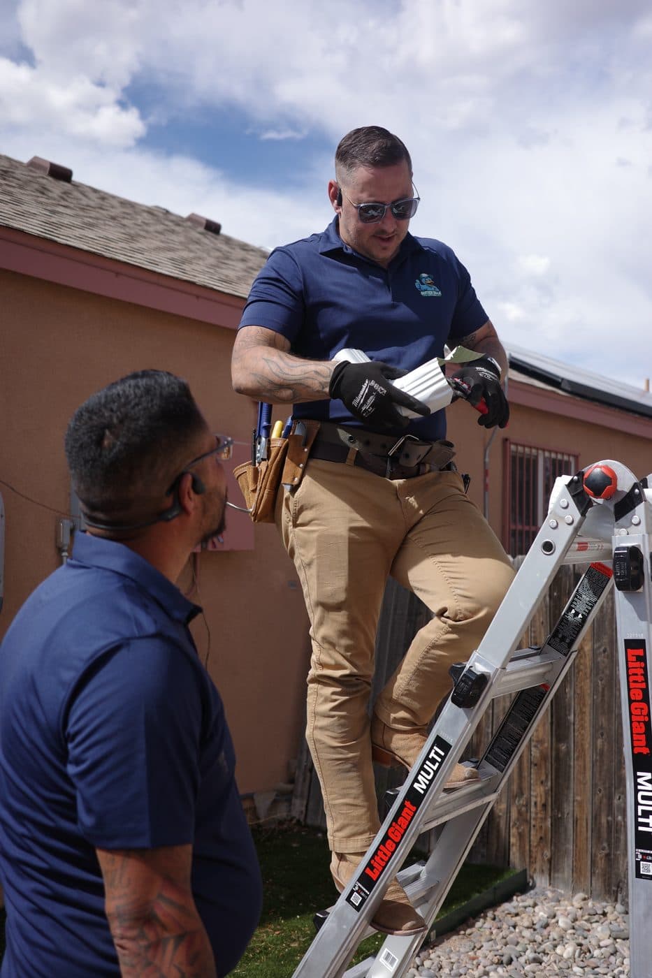 Gutter Duck Gutters technician heading up a ladder on a residential install