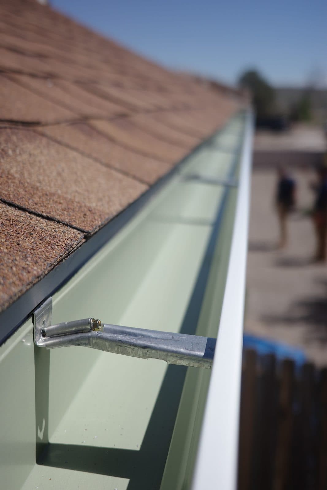 Freshly installed seamless gutter and hidden hanger bracket on an Albuquerque home
